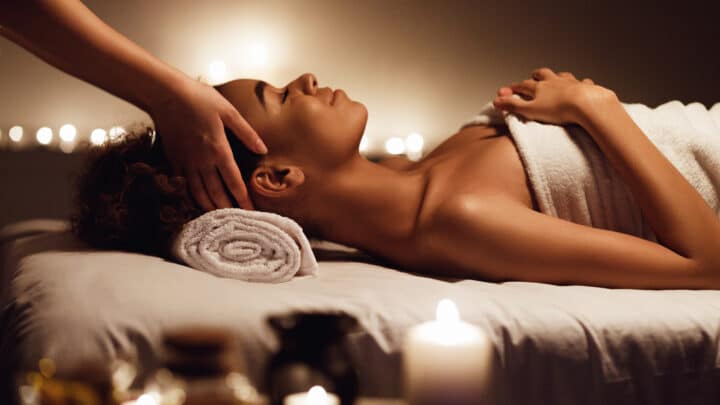 Woman getting massage in candlelit room